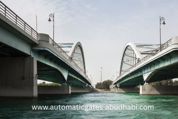 A view of the Al Maqtaa Bridge in Abu Dhabi, showcasing the elegant curved architecture of the bridge over clear turquoise waters.