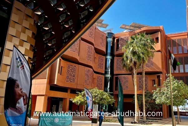 view of the modern and sustainable buildings in Masdar City, Abu Dhabi, with solar panels, greenery, and flags on display in a vibrant urban setting.