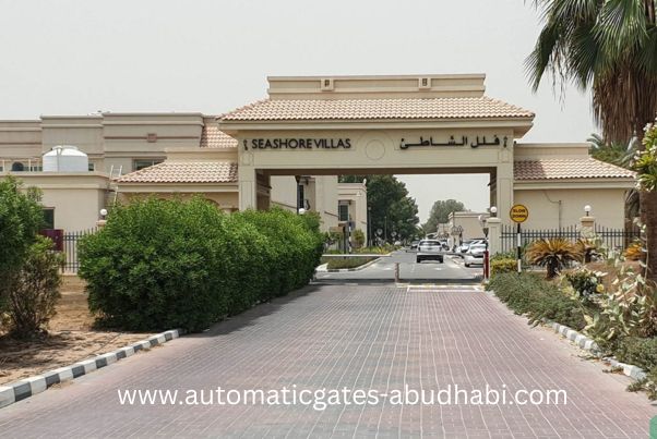 The entrance to Seashore Villas community in Rabdan, Abu Dhabi, featuring a gated entryway and landscaped surroundings.