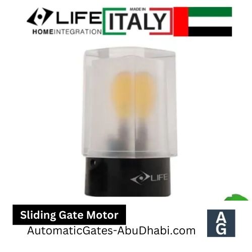 Small, transparent housing encloses a sliding gate motor with a visible light bulb.