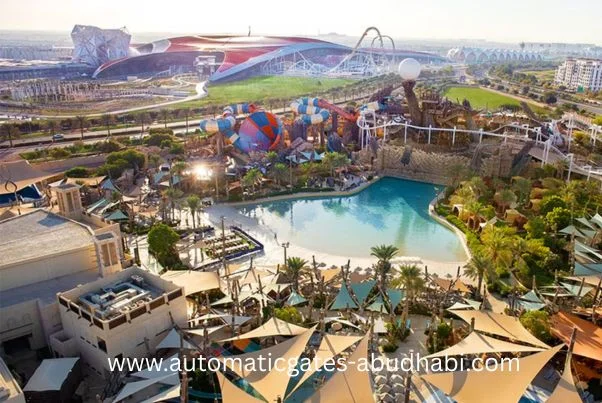 A panoramic view of the Yas Island theme park in Abu Dhabi, showcasing water attractions, roller coasters, and the distinctive Ferrari World structure.