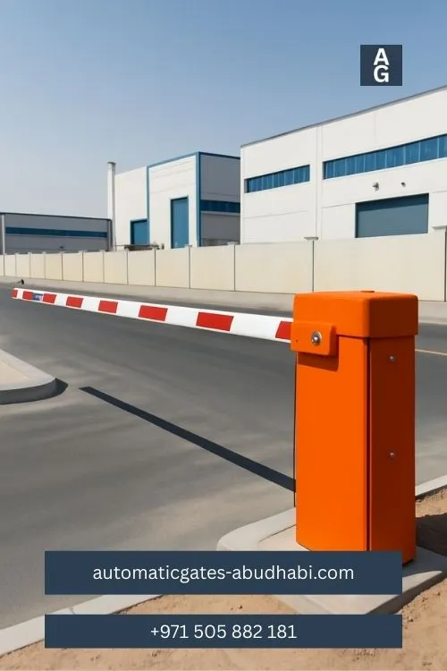 A clear view of an automatic barrier gate with a red and white striped arm blocking the road at an industrial facility entrance.