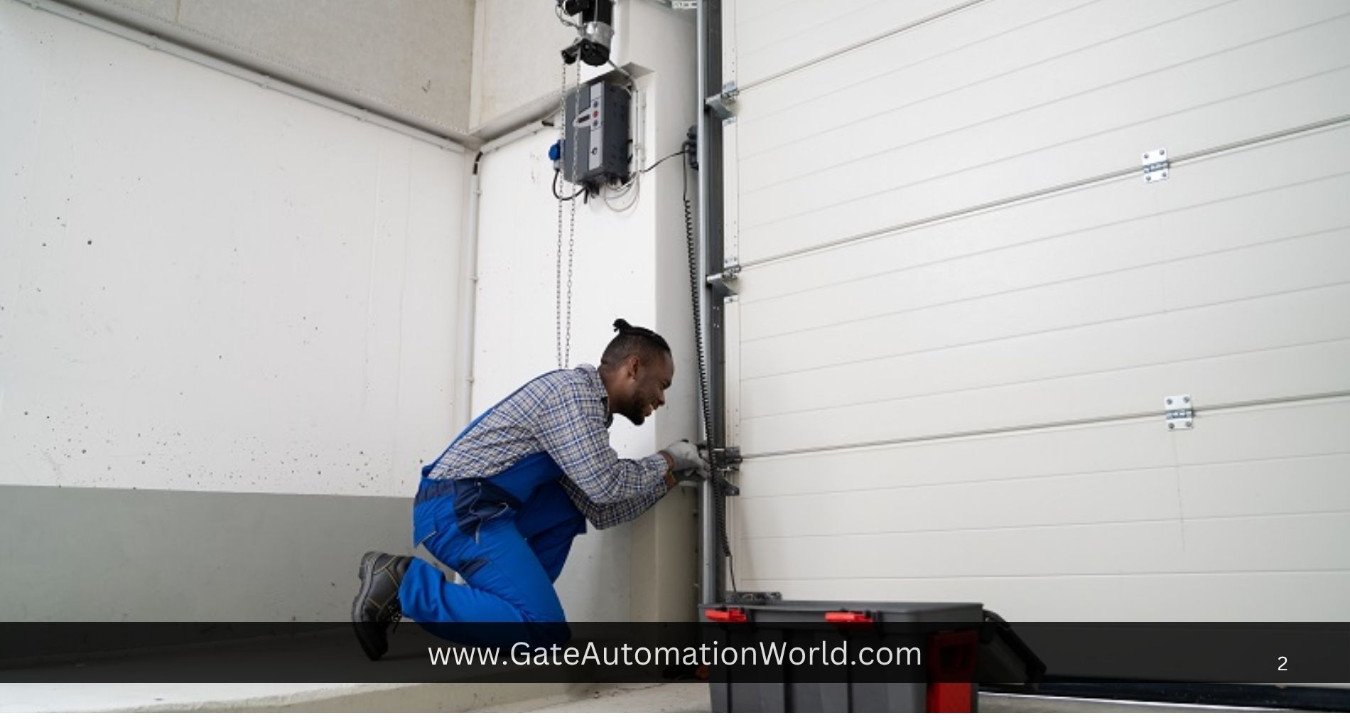 Technician repairing a white automated garage door mechanism in a workshop.