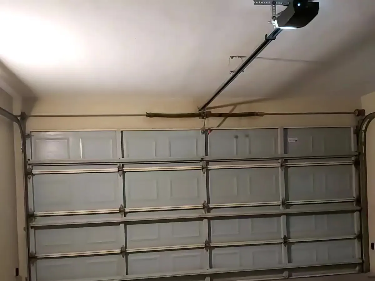 Torsion spring and opener rail above a sectional garage door in Abu Dhabi